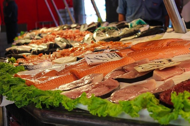 Why is high consumption of fish linked to increased risk of melanoma?